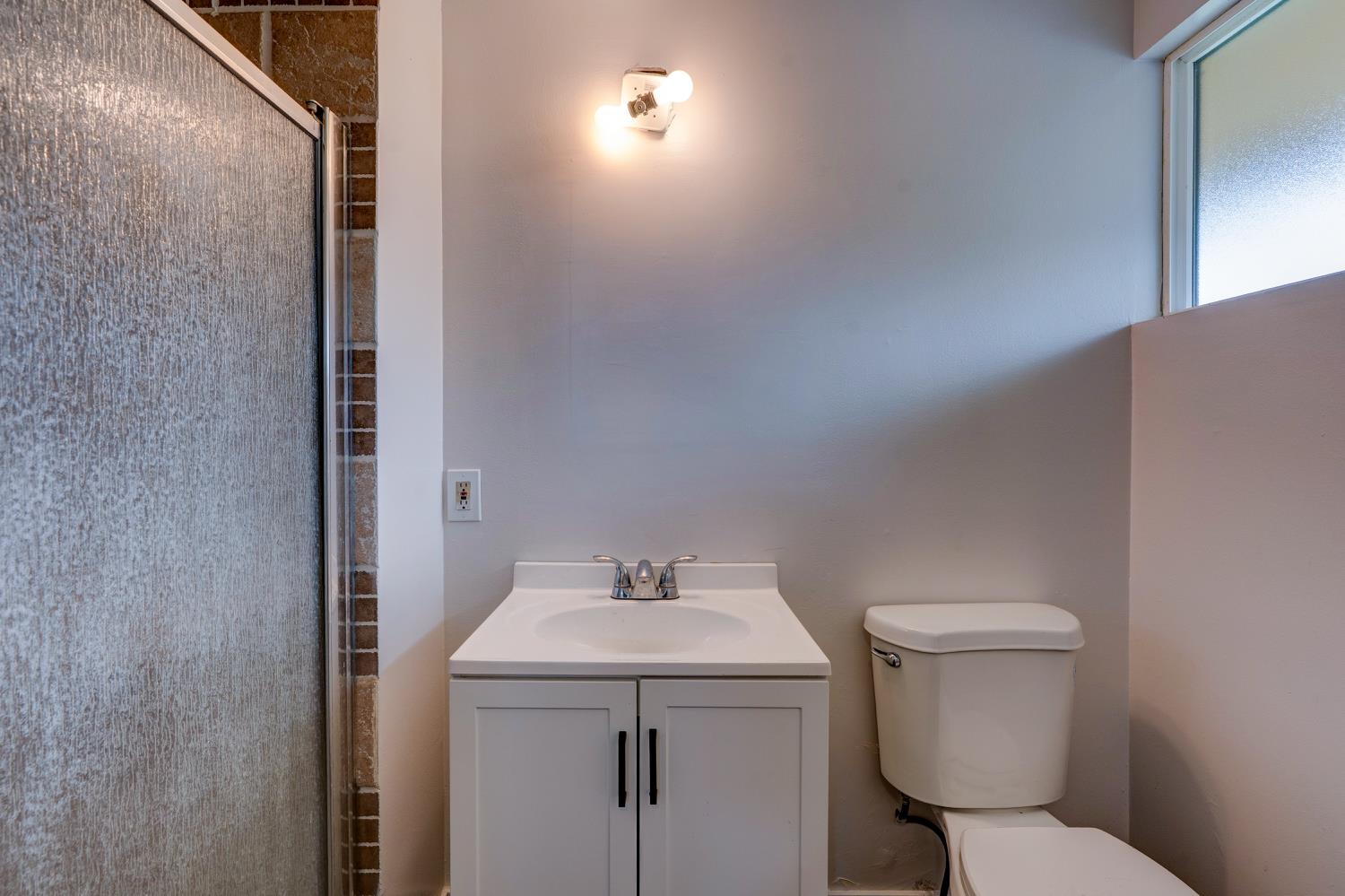 2310 Linden Street Atwater, CA 95301 - Photo 25 of 32 a bathroom with a toilet sink and mirror