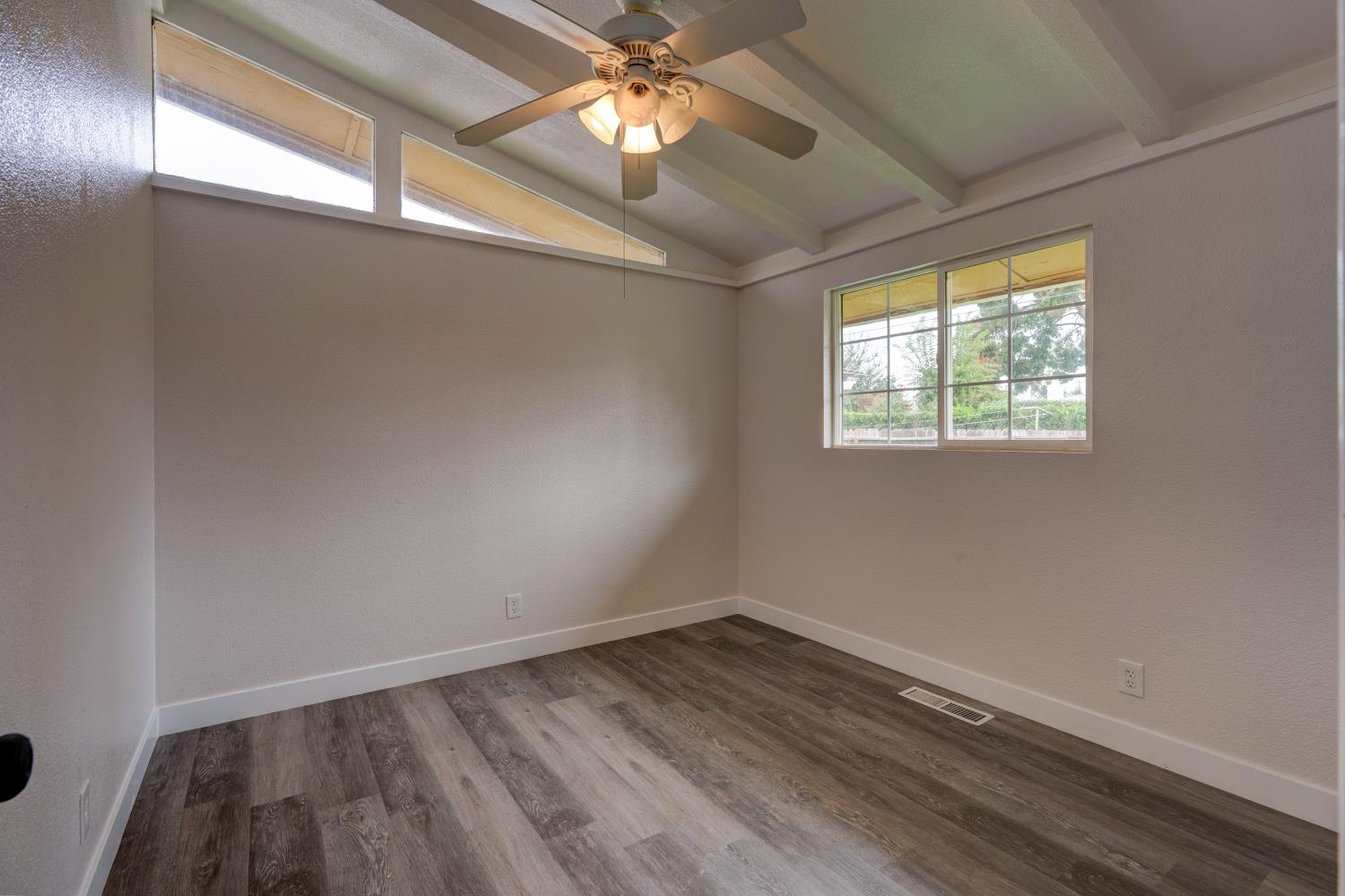 2310 Linden Street Atwater, CA 95301 - Photo 29 of 32 en empty room with wooden floor and windows