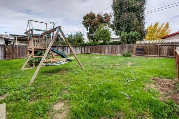 a view of a house with a park and a slide