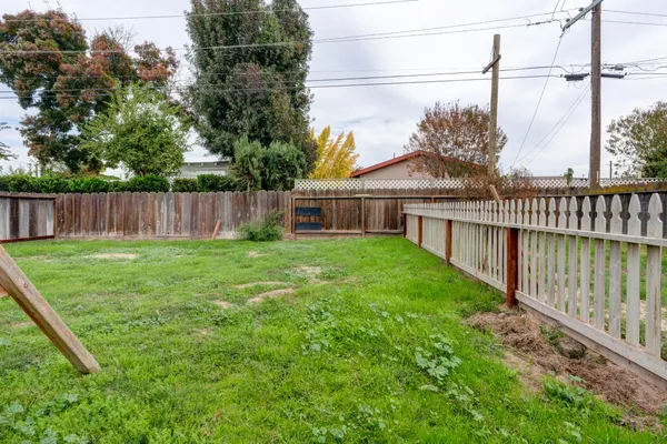 a view of a house with backyard and a hammock