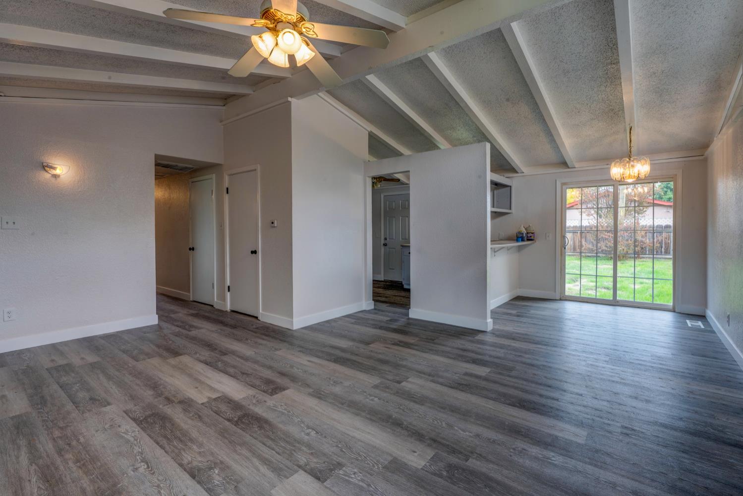 2310 Linden Street Atwater, CA 95301 - Photo 9 of 32 a view of an empty room with wooden floor and a window
