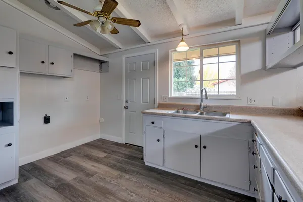 a kitchen with a sink cabinets and window