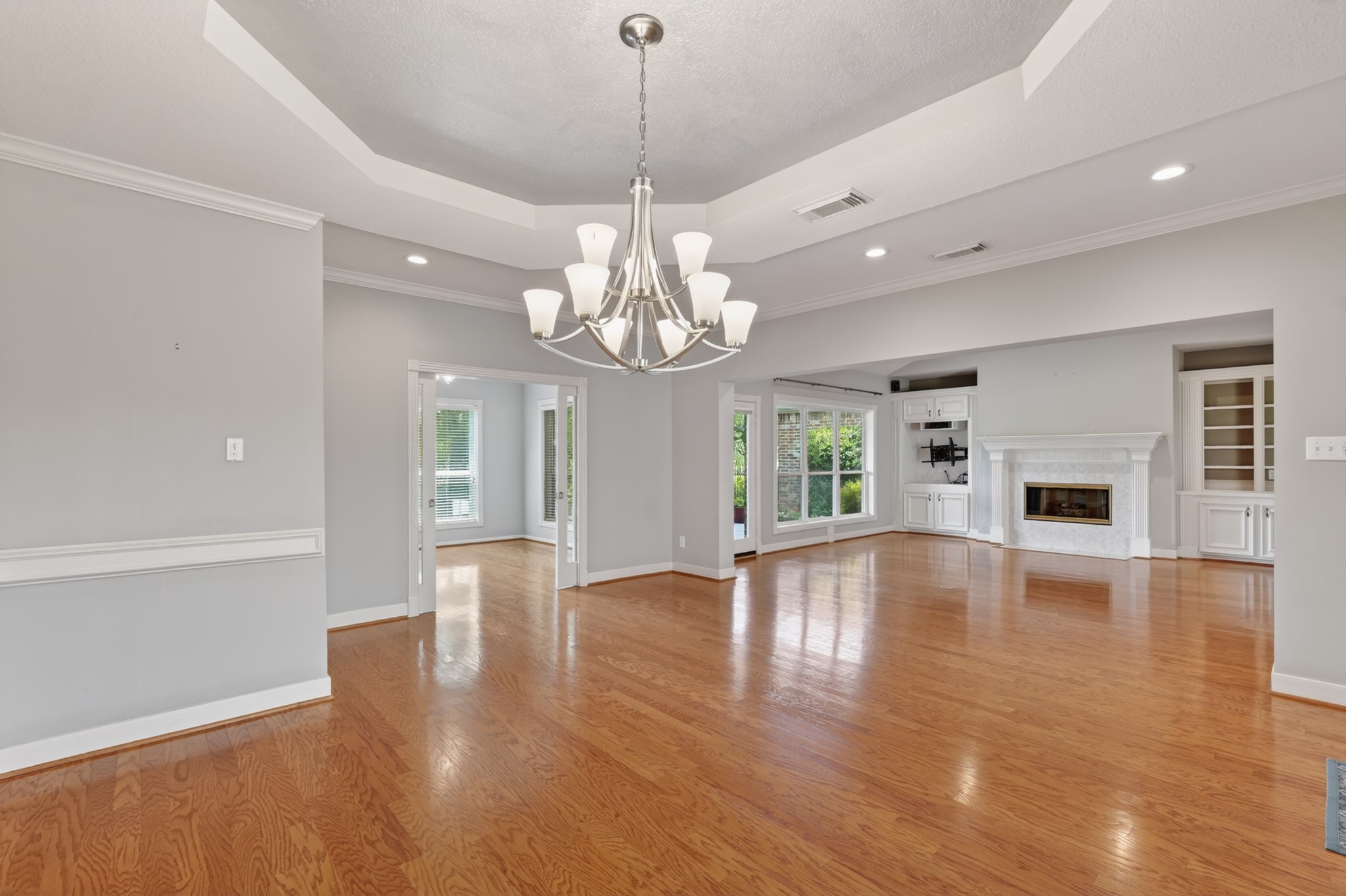 20714 Flora View Court Spring, TX 77379 - Photo 10 of 40 a view of an empty room with wooden floor and a window