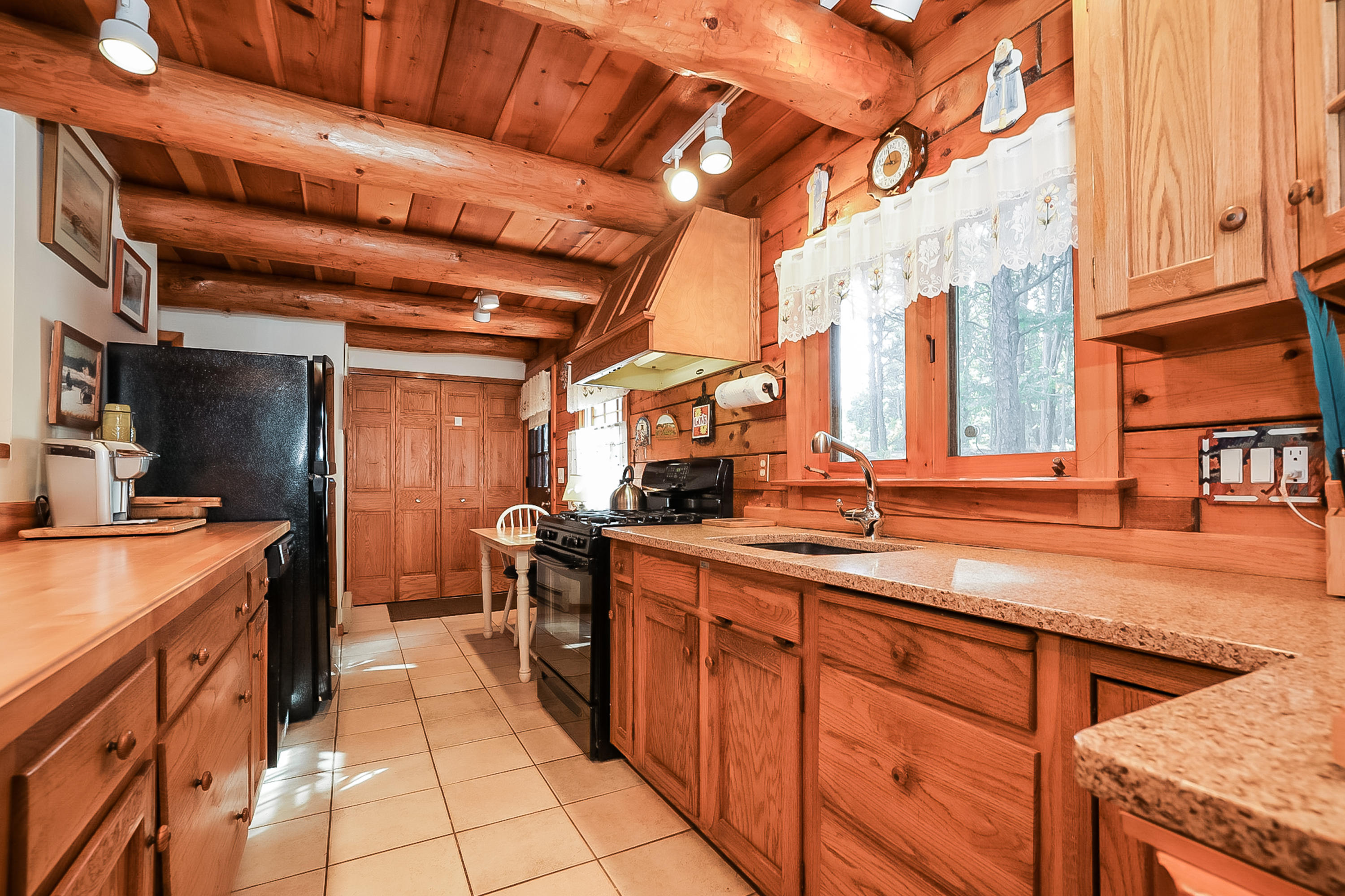 a kitchen with stainless steel appliances granite countertop a sink and a stove