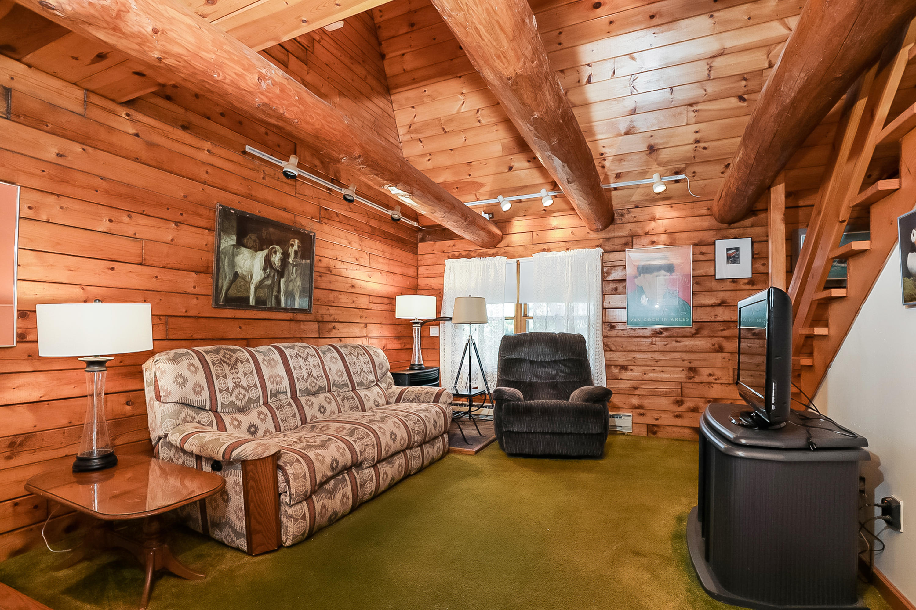 53 E Street Wellfleet, MA 02642 - Photo 11 of 41 a living room with furniture and a chandelier