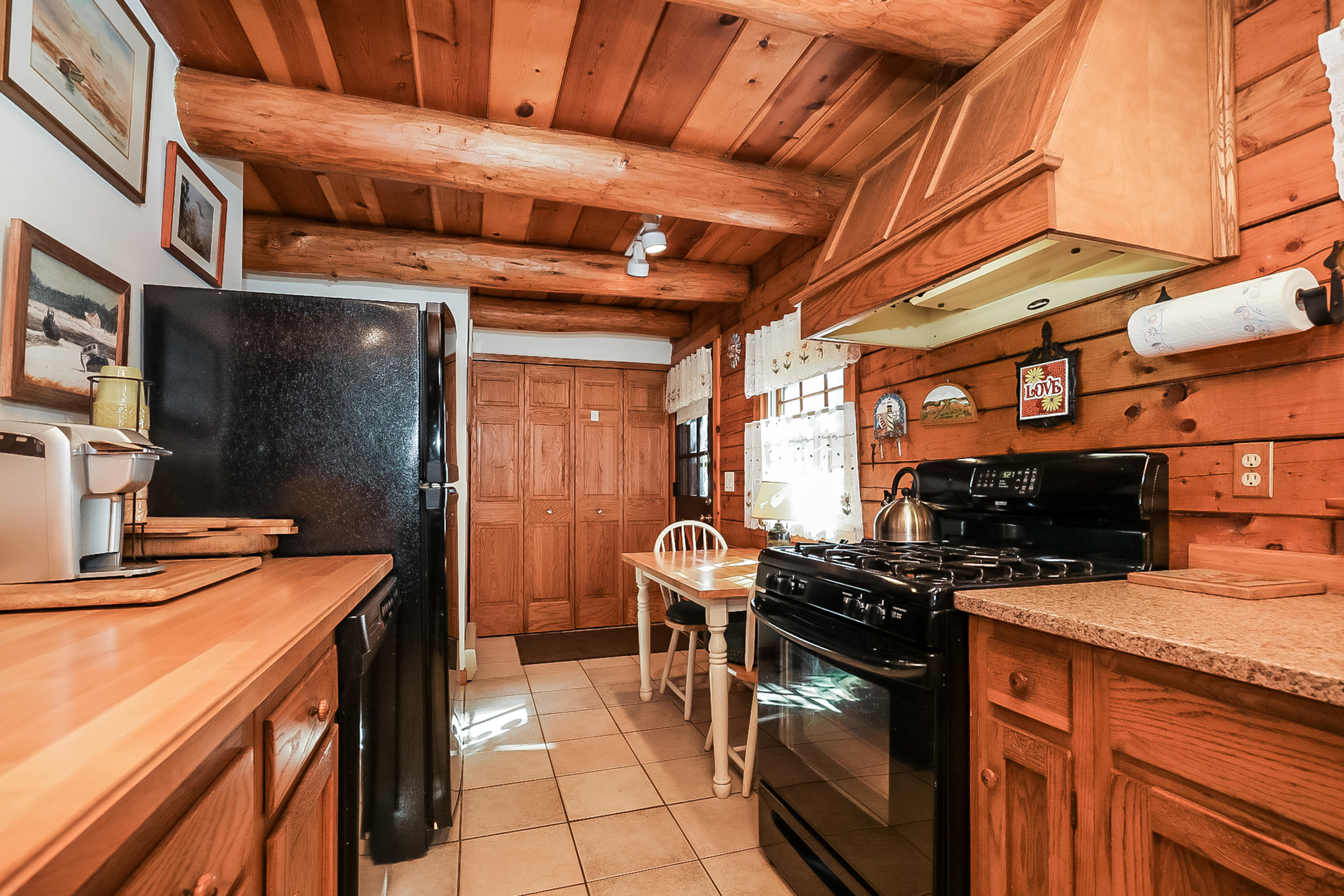 53 E Street Wellfleet, MA 02642 - Photo 15 of 41 a kitchen with stainless steel appliances granite countertop a stove a sink and a microwave