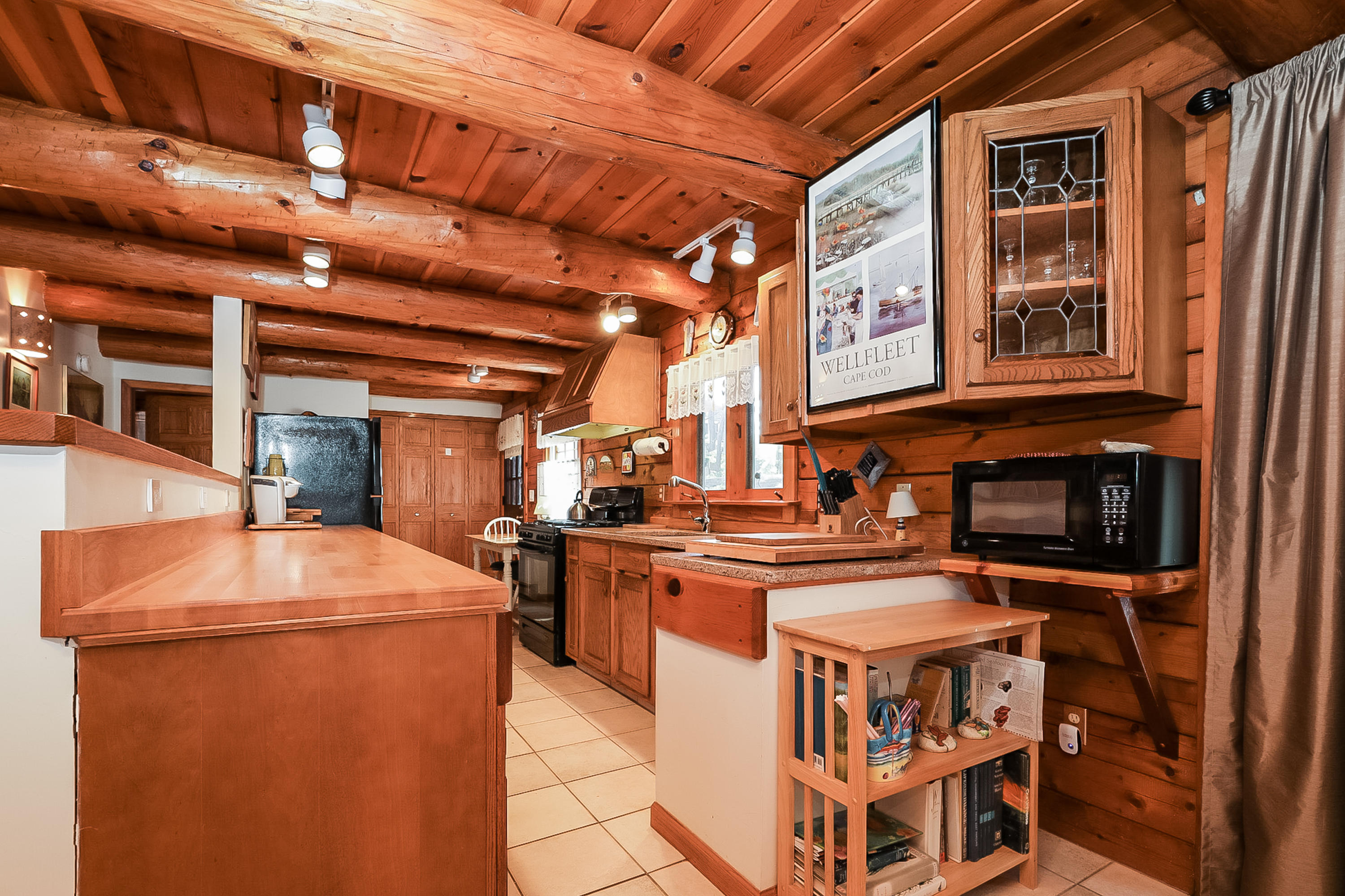 53 E Street Wellfleet, MA 02642 - Photo 16 of 41 a open kitchen with stainless steel appliances granite countertop a stove and a refrigerator