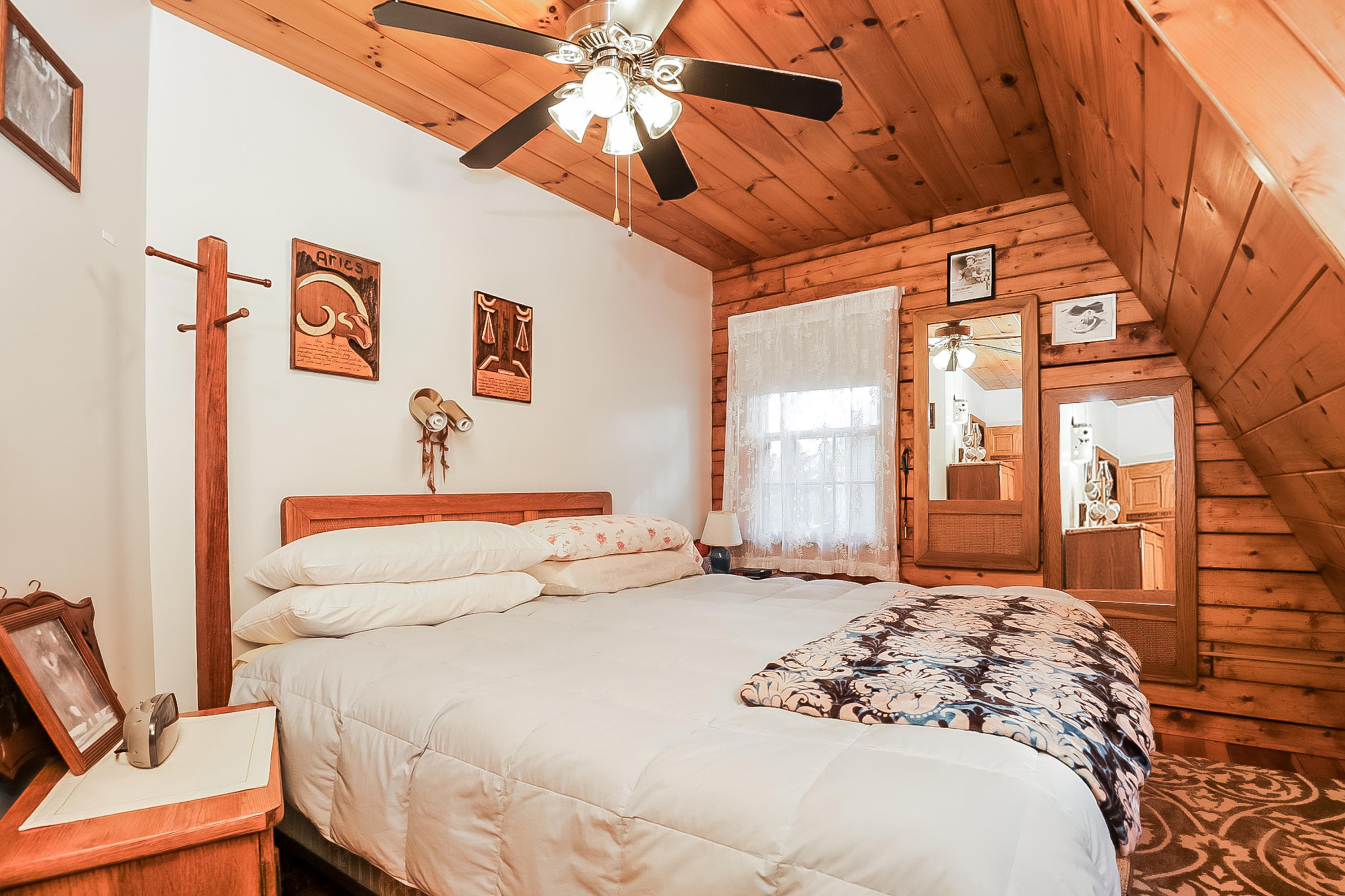 53 E Street Wellfleet, MA 02642 - Photo 19 of 41 a bedroom with a bed and a chandelier