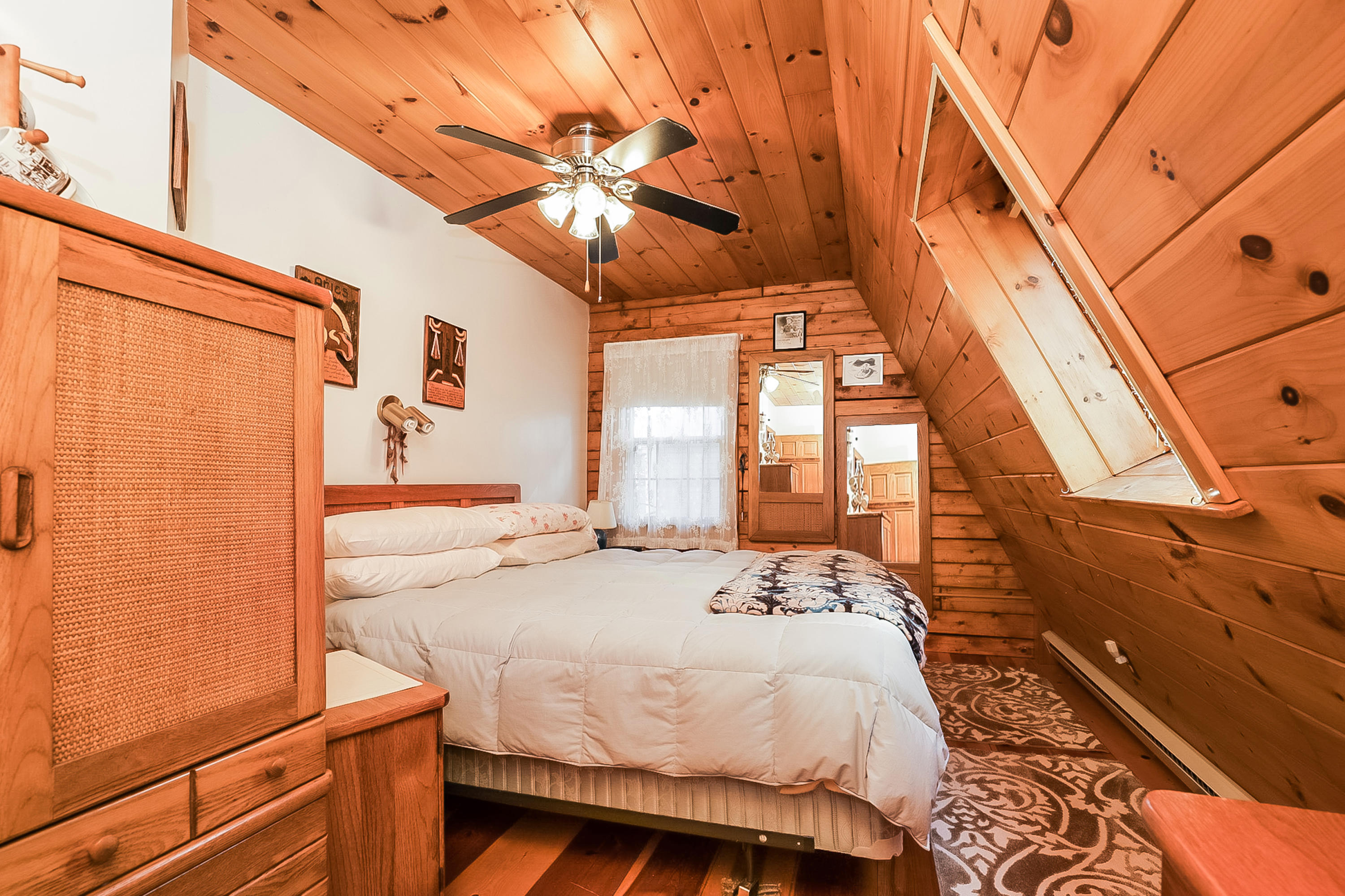 53 E Street Wellfleet, MA 02642 - Photo 20 of 41 a bedroom with a bed and a chandelier