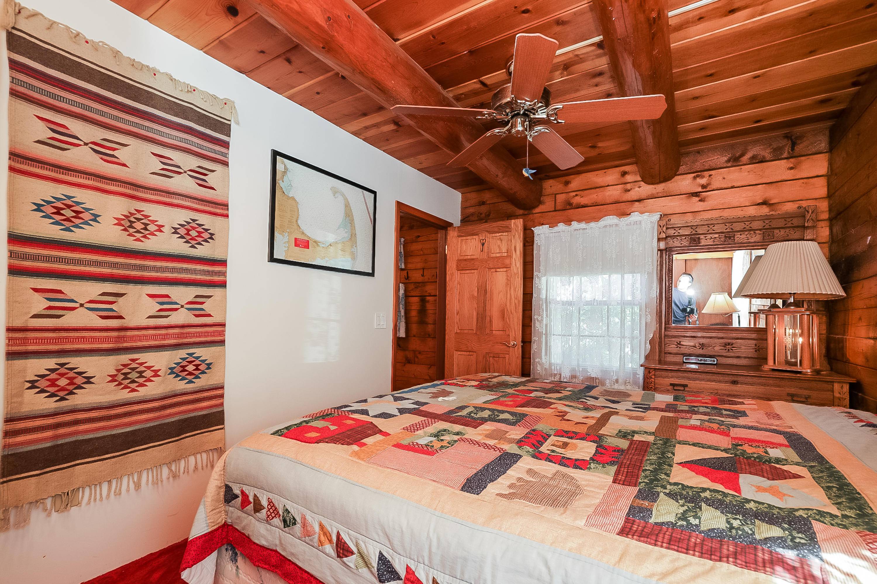 53 E Street Wellfleet, MA 02642 - Photo 30 of 41 a bedroom with a bed and a large mirror on the dresser