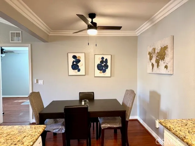 a view of a workspace with furniture and wooden floor