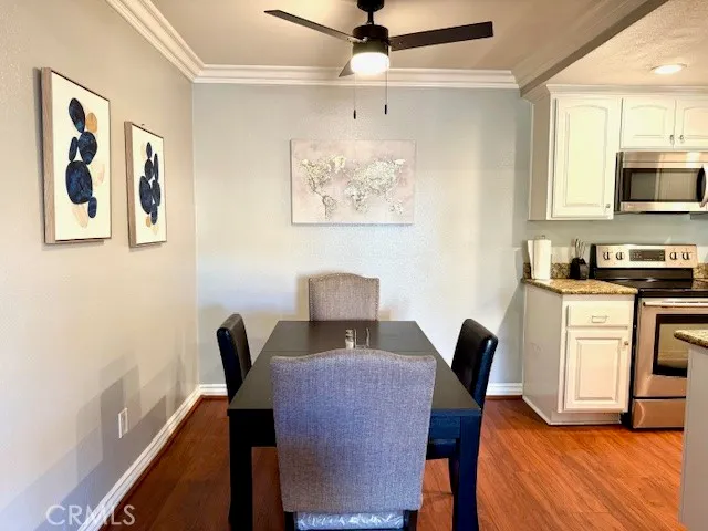 a view of a workspace with furniture and wooden floor