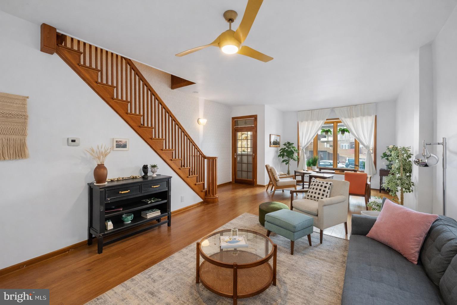 a living room with furniture and a potted plants