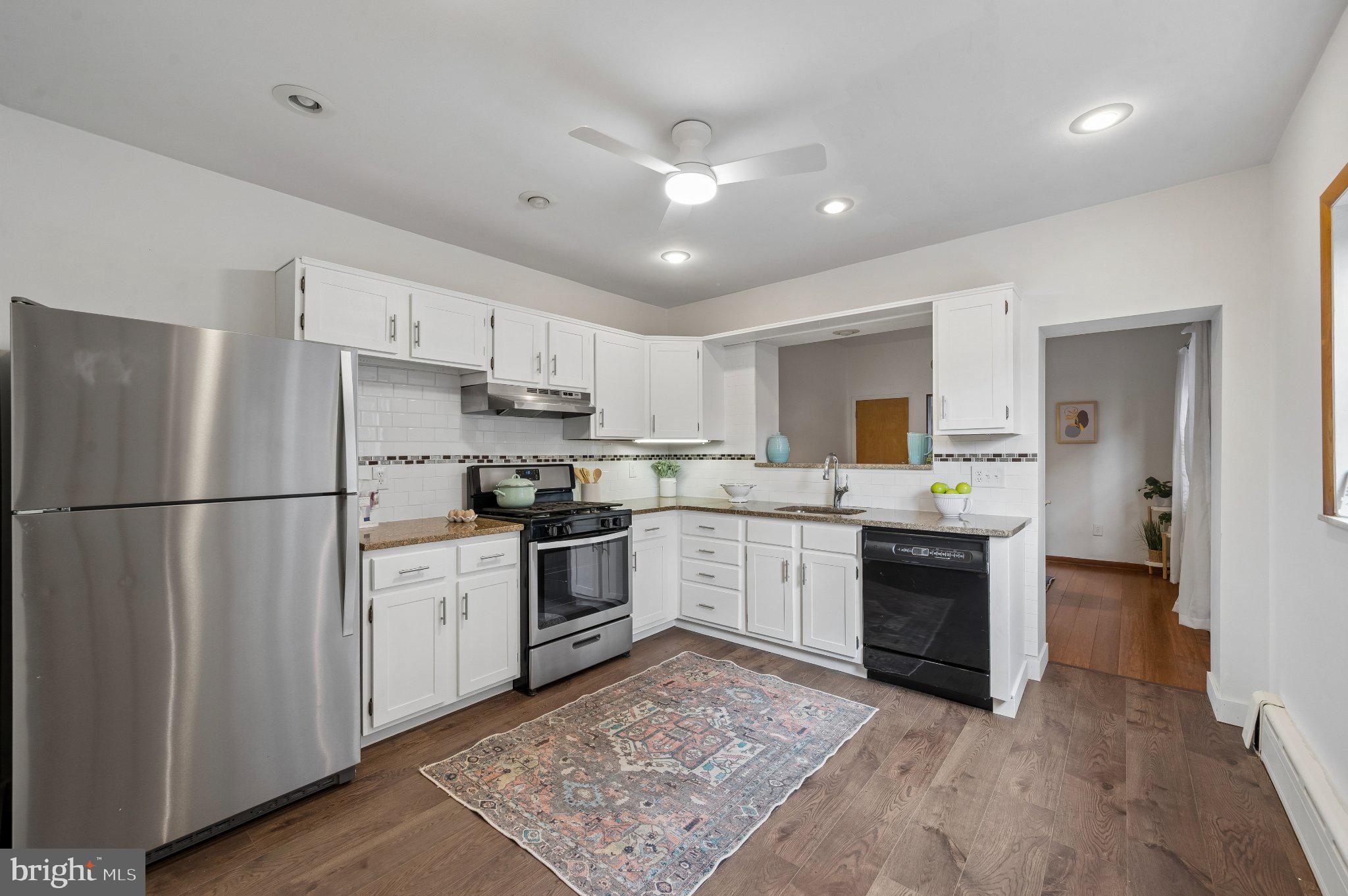 3346 Edgemont Street Philadelphia, PA 19134 - Photo 12 of 25 a kitchen with a refrigerator stove top oven and sink