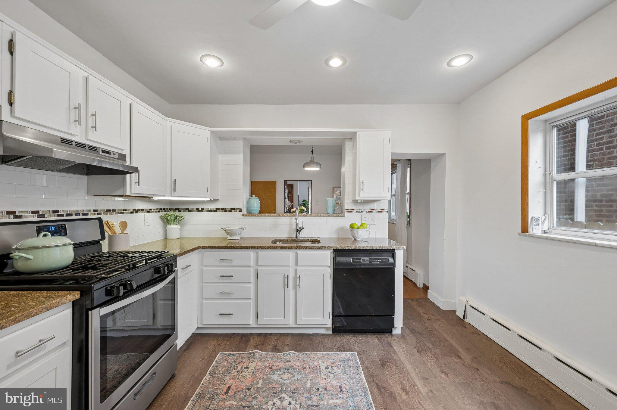 3346 Edgemont Street Philadelphia, PA 19134 - Photo 13 of 25 a kitchen with a sink stove and cabinets