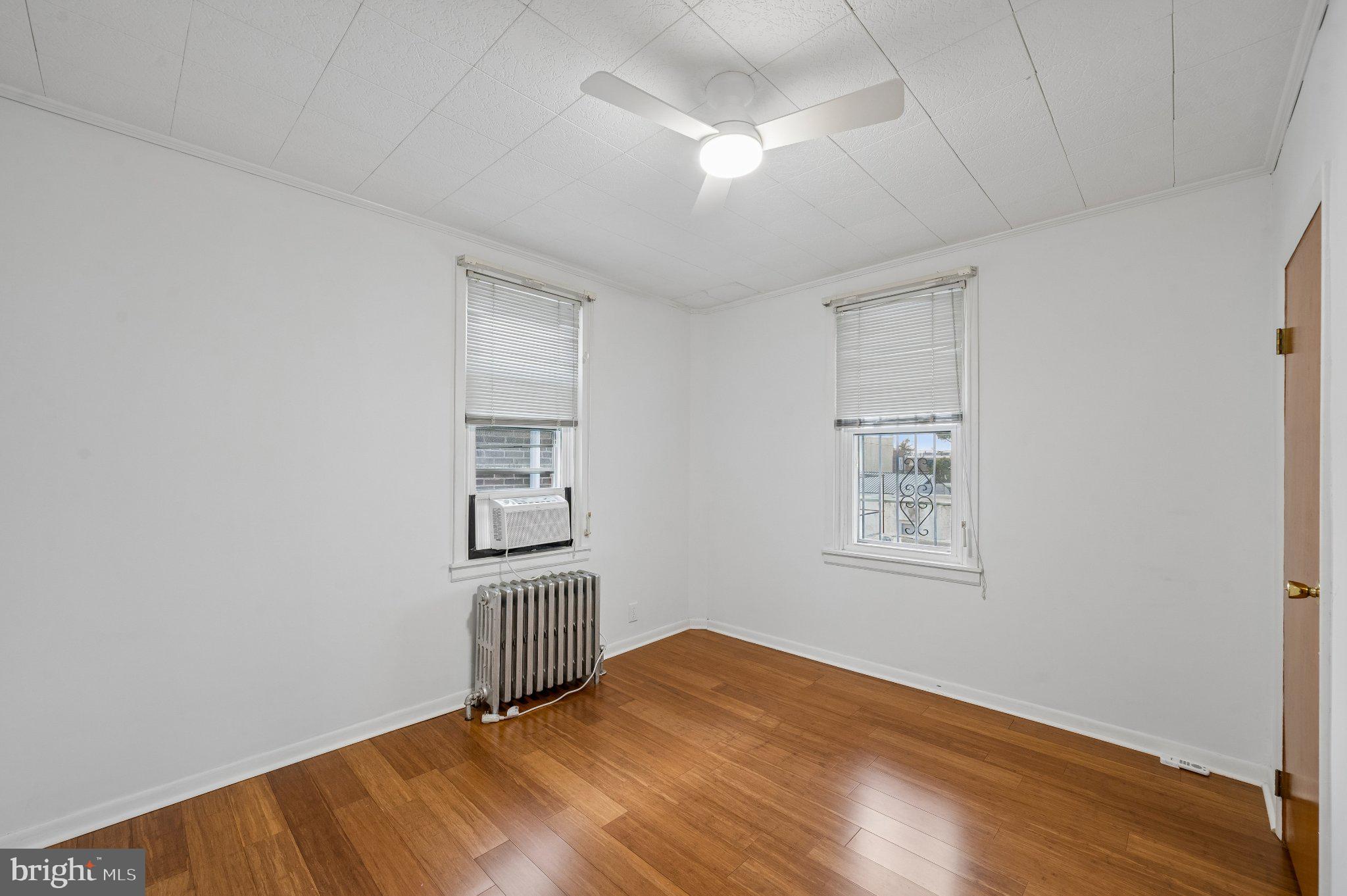 3346 Edgemont Street Philadelphia, PA 19134 - Photo 19 of 25 a view of empty room with wooden floor and fan