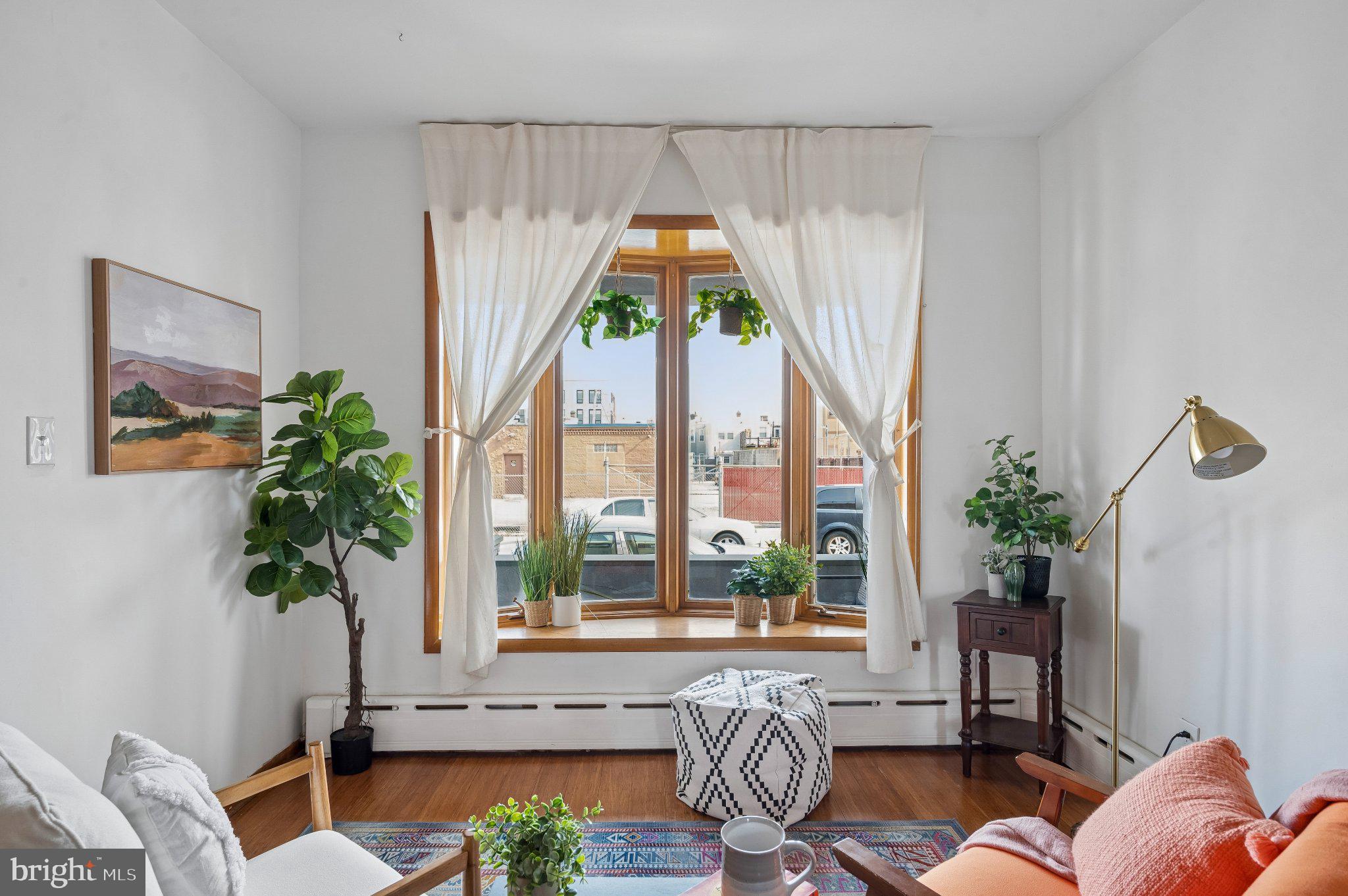 3346 Edgemont Street Philadelphia, PA 19134 - Photo 3 of 25 a living room filled with furniture and a potted plant