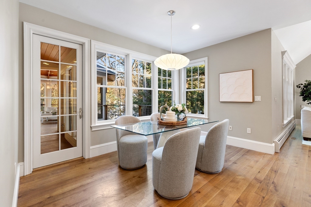22 Fairbanks Road Lexington, MA 02421 - Photo 17 of 41 a dining room with wooden floor and large windows
