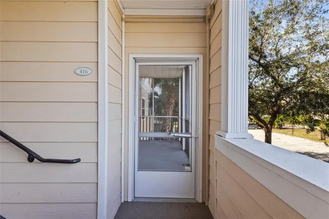 a view of a porch with a floor to ceiling window