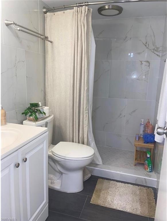 3 Bluebill Avenue, Unit 211 Naples, FL 34108 - Photo 4 of 8 a bathroom with a sink toilet and shower