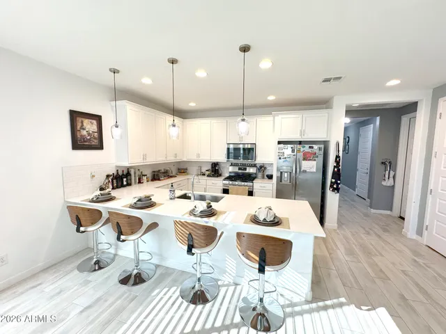 a large kitchen with a table and chairs