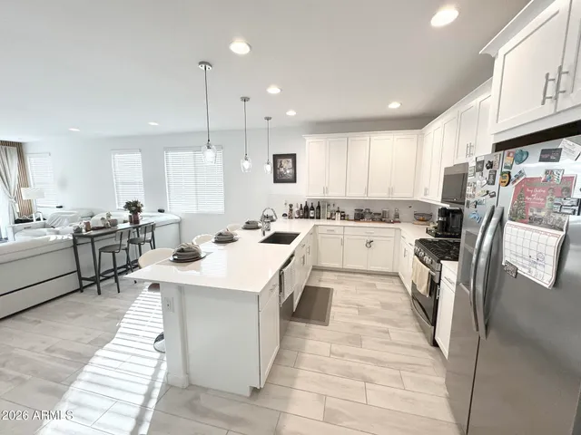 a kitchen with stainless steel appliances kitchen island granite countertop a sink and cabinets