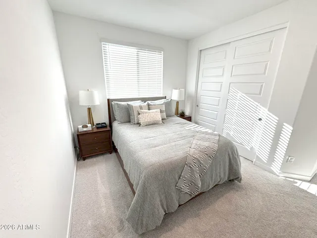 a bedroom with a bed and a window