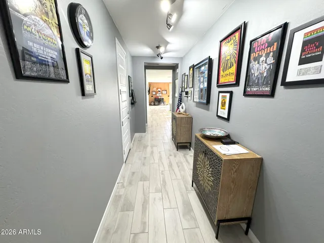 a view of a hallway with paintings on the wall