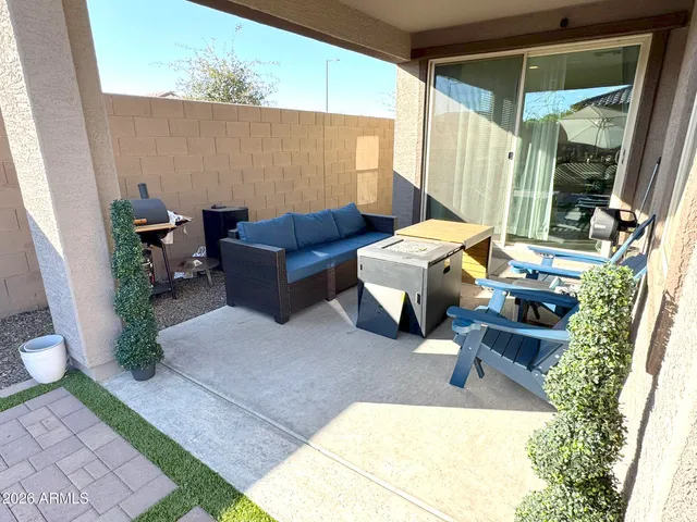 a view of a patio with couches chairs and wooden floor