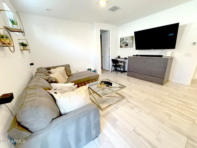 a bedroom with a bed and a large window