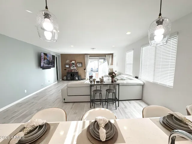 a living room with furniture a chandelier and a window
