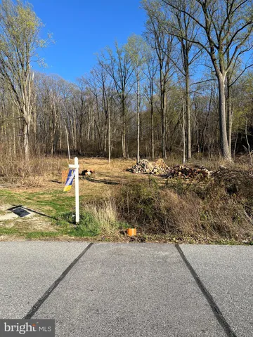 a view of a house with a yard covered with snow