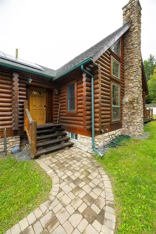a view of a house with swimming pool and sitting area