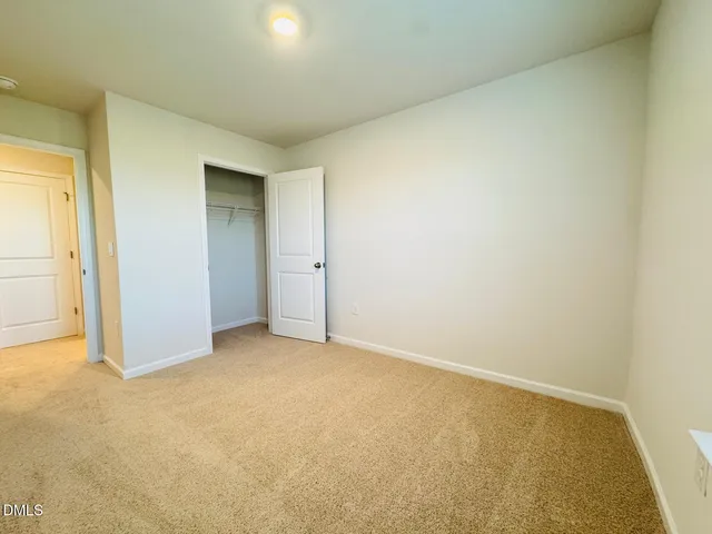 an empty room with closet area