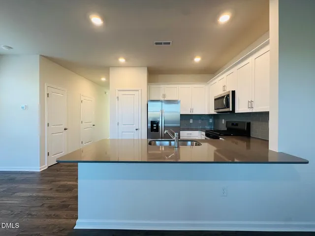 a large kitchen with lots of counter space and refrigerator