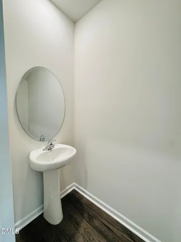a bathroom with a sink a mirror and toilet