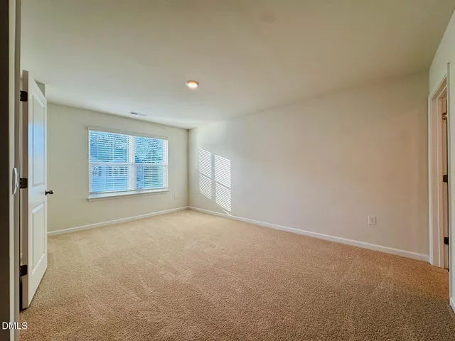 an empty room with a empty space and windows