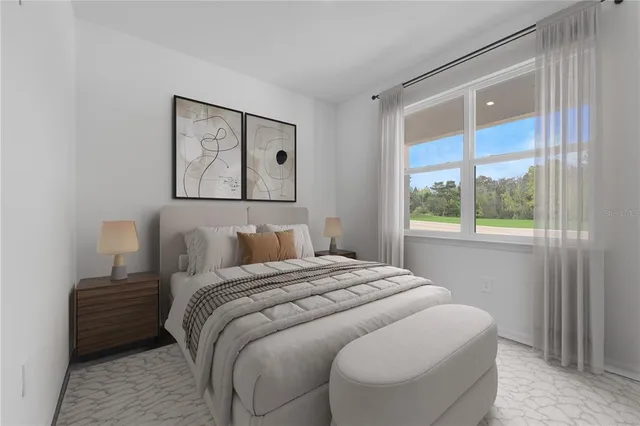 a bedroom with a large bed and a window