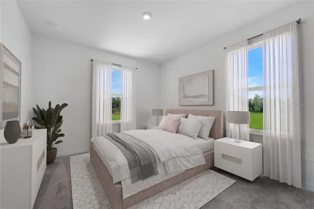 a bedroom with a bed and a potted plant