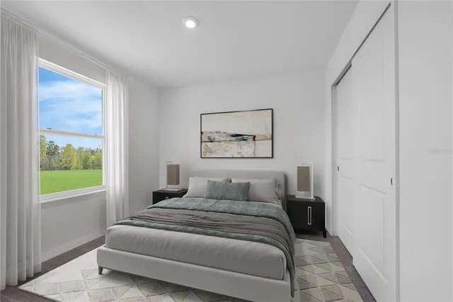 a bedroom with a bed and a painting on the wall