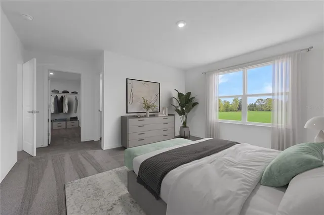 a bedroom with a bed and a large window