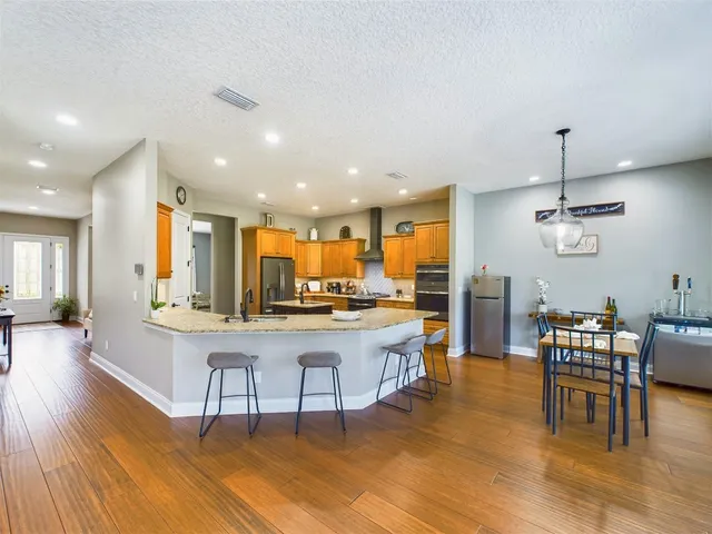 a view of a house with a yard and potted plants
