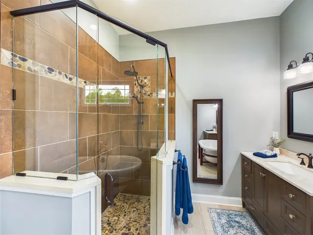 a view of a house with a big yard and large trees