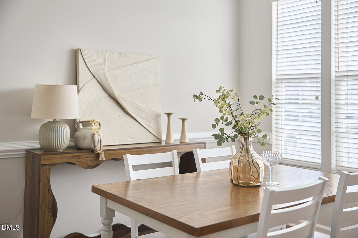 638 Cupola Drive Raleigh, NC 27603 - Photo 14 of 43 a table with a vase and flowers on it