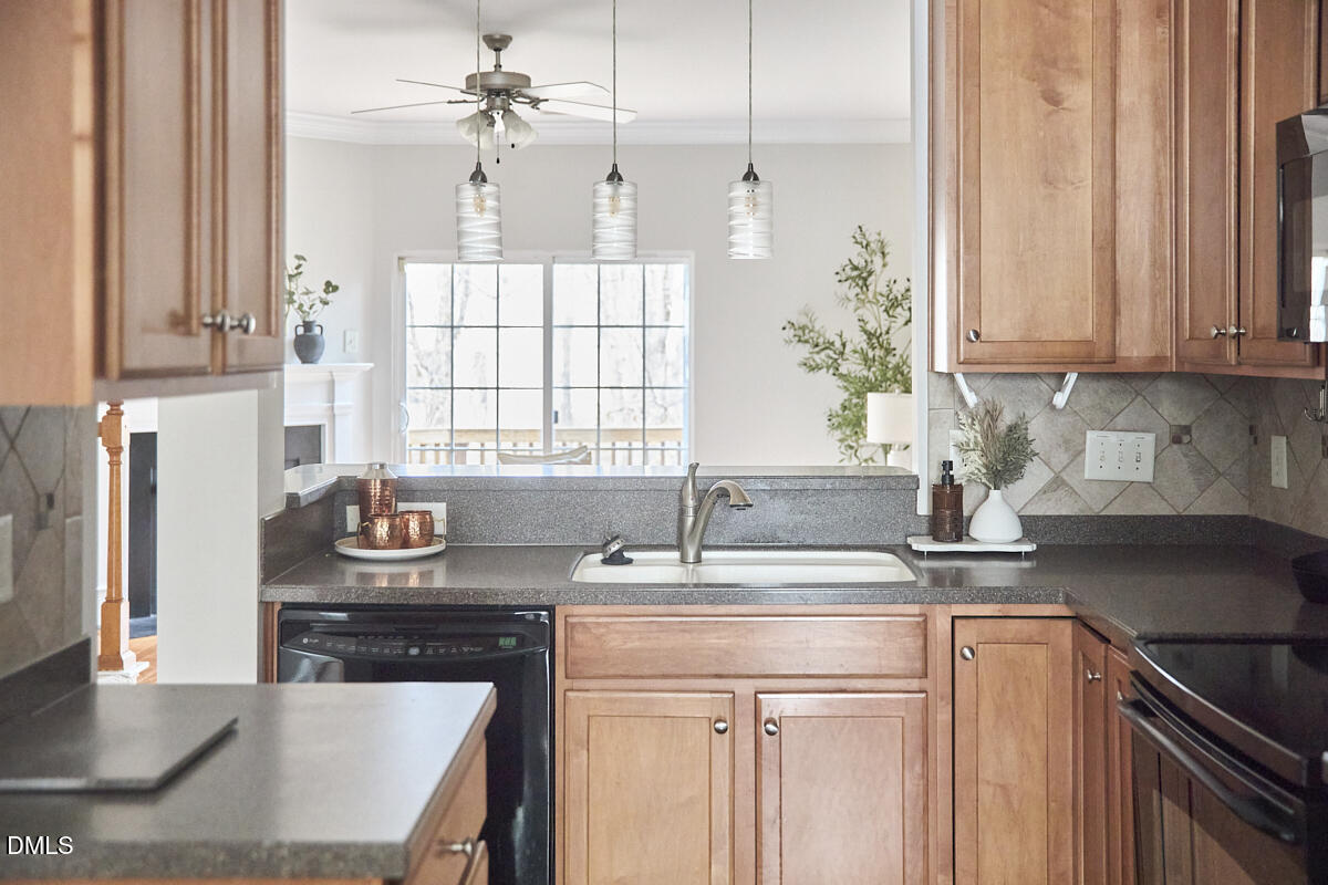 638 Cupola Drive Raleigh, NC 27603 - Photo 17 of 43 a kitchen with stainless steel appliances granite countertop a sink stove and cabinets