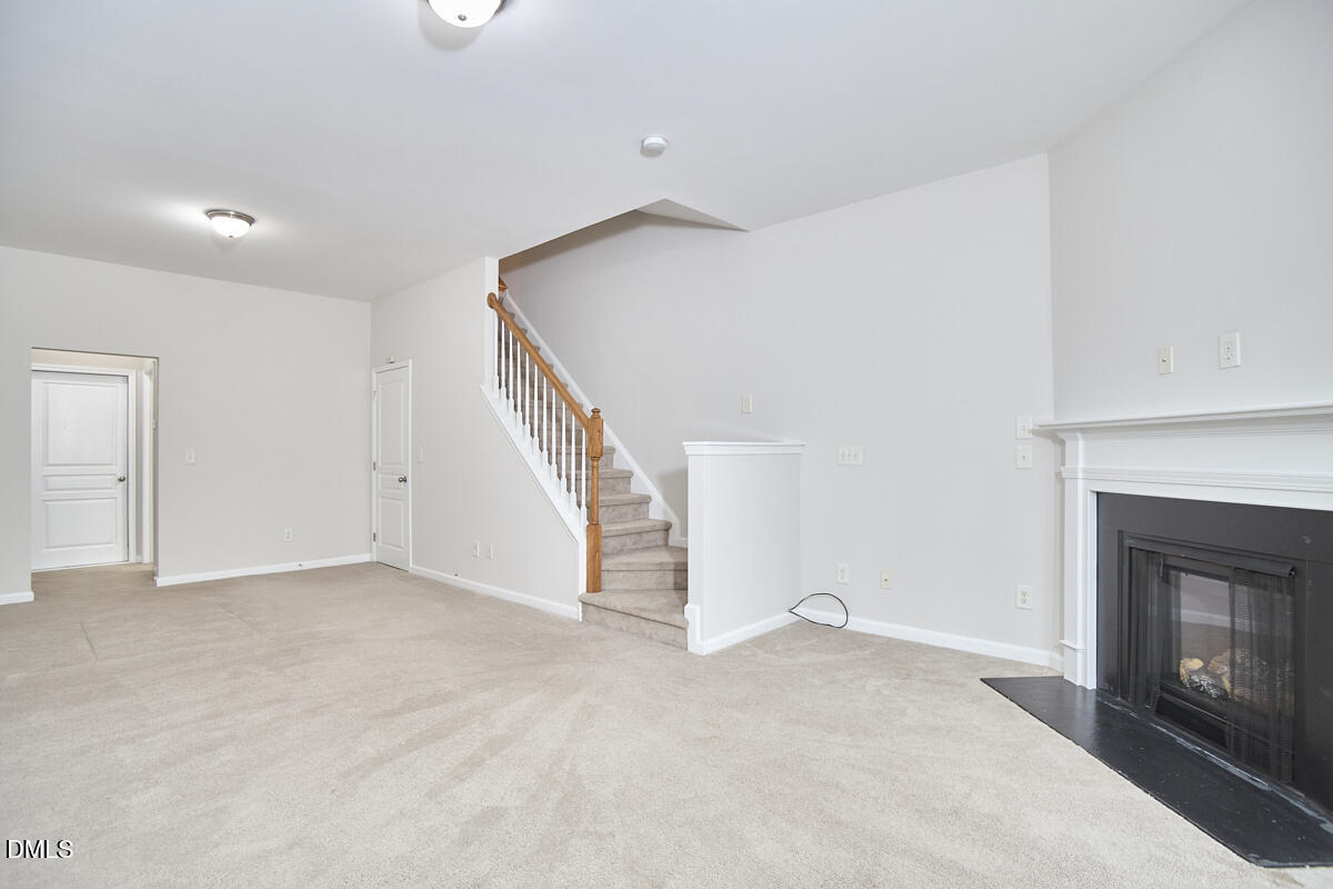 638 Cupola Drive Raleigh, NC 27603 - Photo 37 of 43 a view of an empty room with wooden floor fireplace and a window