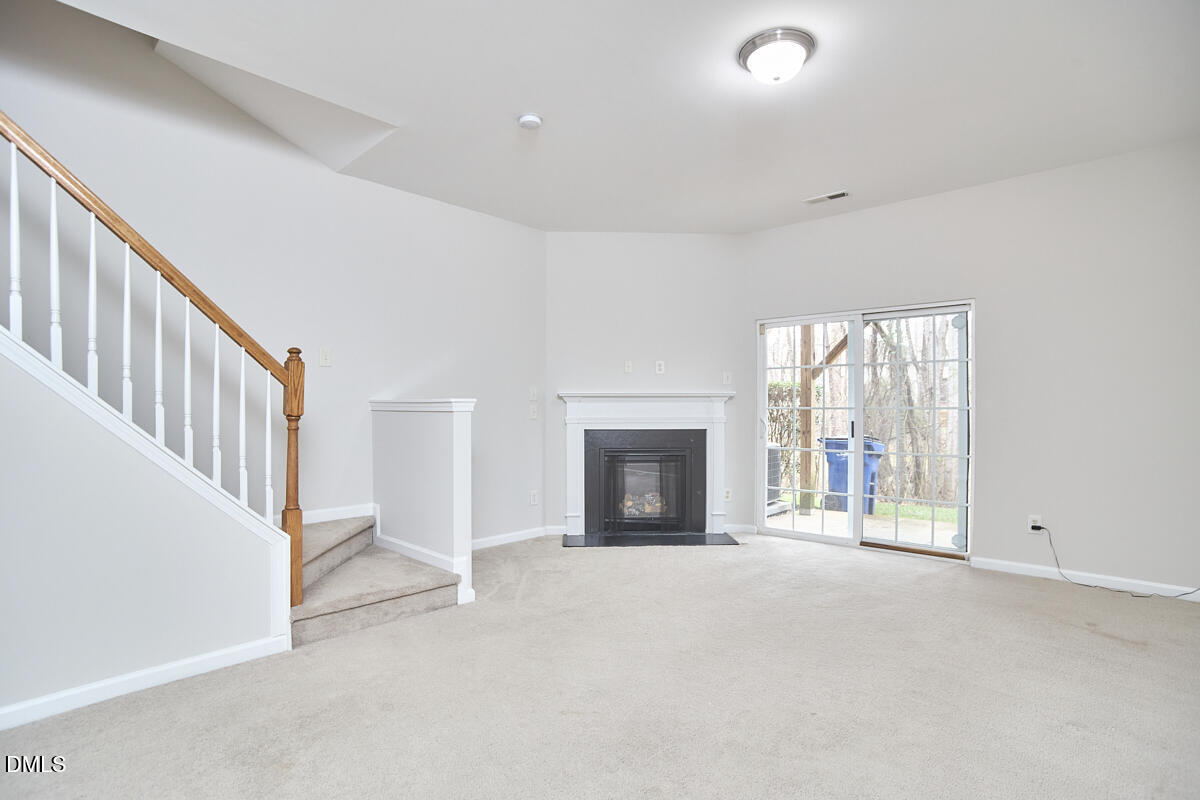 638 Cupola Drive Raleigh, NC 27603 - Photo 38 of 43 a view of an empty room with a fireplace and a window