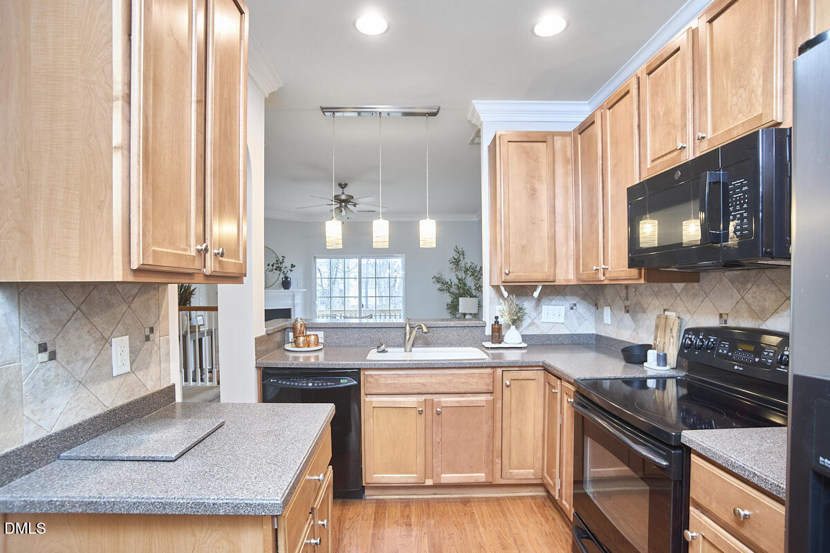 638 Cupola Drive Raleigh, NC 27603 - Photo 7 of 43 a kitchen with stainless steel appliances a stove sink microwave and cabinets