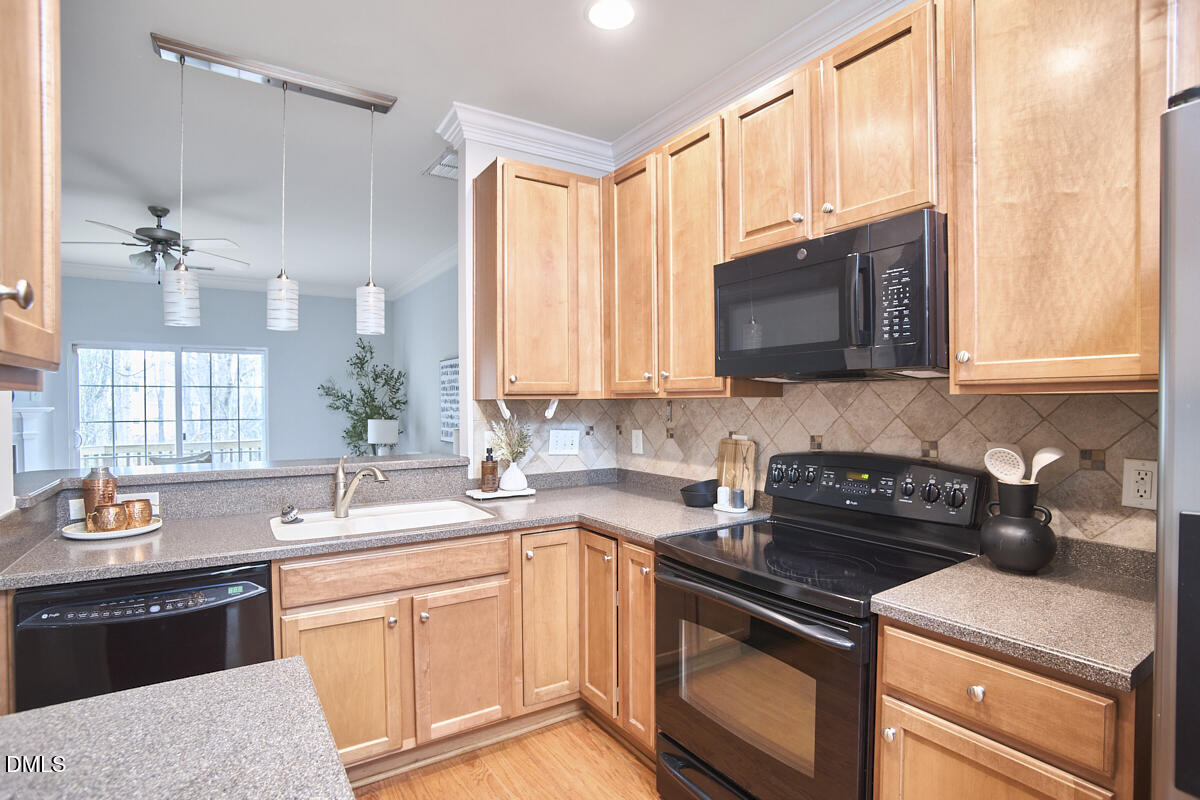 638 Cupola Drive Raleigh, NC 27603 - Photo 8 of 43 a kitchen with stainless steel appliances granite countertop a sink stove and microwave