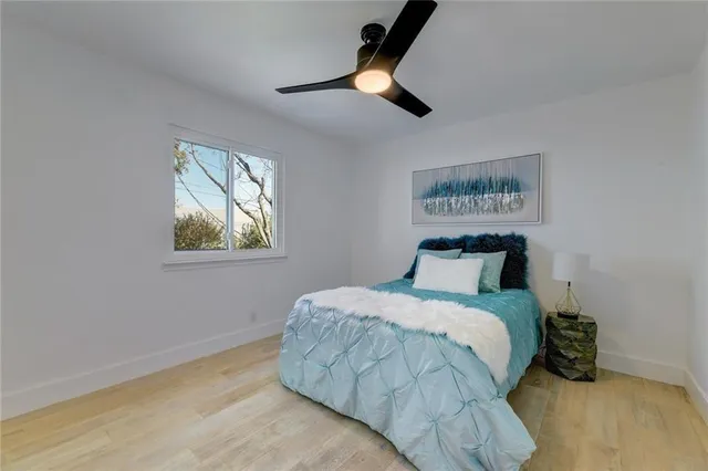 a bedroom with a bed and a painting on the wall